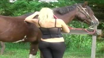 Blondie with round bottom fucks with an awesome stallion on the grass