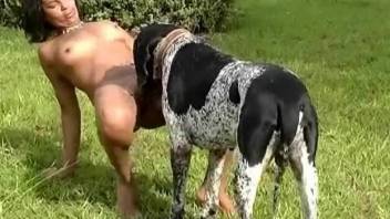 Naked female sucks and fucks with a dog in outdoor