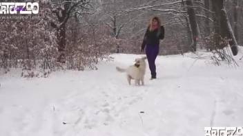 Colorful blonde gets fucked by a dog in the snow