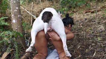 Tanned woman fucked by the dog out into the woods