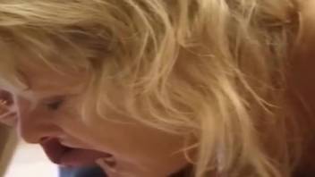 Golden-haired vixen reveres a canine's fiery member