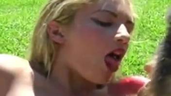Slim blonde chick recorded deepthroating a massive canine cock