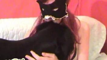 Masked zoophile with pink hairs trains her dog